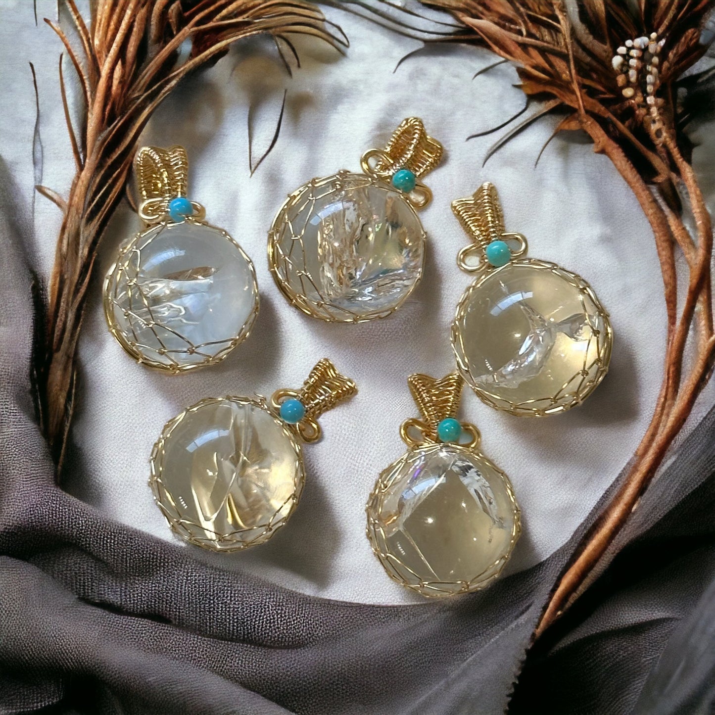 Clear quartz sphere pendant in gold wire cage